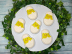 Six just hatched baby chick bath bombs on a white round display with ivy trimming the round display